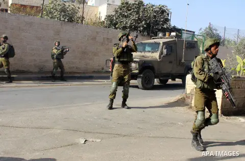 Israeli security forces take position during clashes with Palestinian protesters following at al-Arrub refugee camp, north of Hebron in the southern West Bank on November 13, 2019. Photo by Mosab Shawer