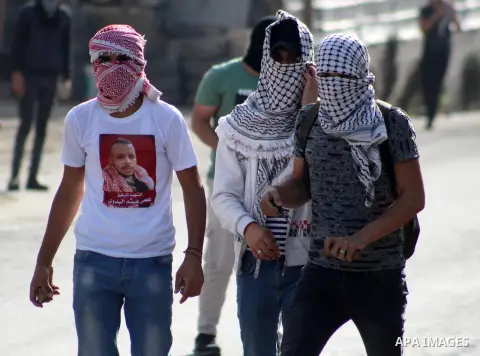 Palestinian protesters hurl stones towards Israeli security forces at al-Arrub refugee camp, north of Hebron in the southern West Bank on November 13, 2019. Photo by Mosab Shawer