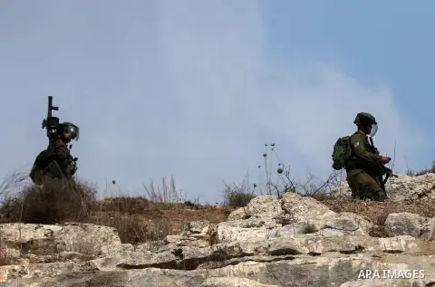 Israeli security forces take position during clashes with Palestinian protesters following a weekly demonstration against the expropriation of Palestinian land by Israel in the village of Kfar Qaddum, near the West Bank...