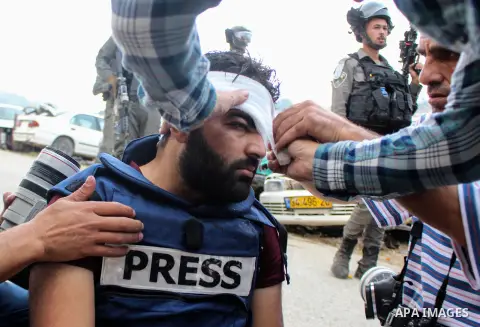 Palestinian cameraman Muath Amara is injured as he covers the clashes between Palestinians and Israeli forces in the West Bank village of Surif, near Hebron, November 15, 2019. Photo by Mosab Shawer