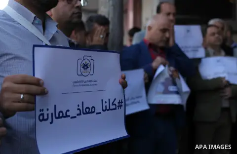 Palestinian journalists are pasted on the eyes during a protest to show solidarity with Muath Amarna, who was shot in his eye, in the Gaza city, on November 17, 2019. Photo by Mahmoud Ajjour