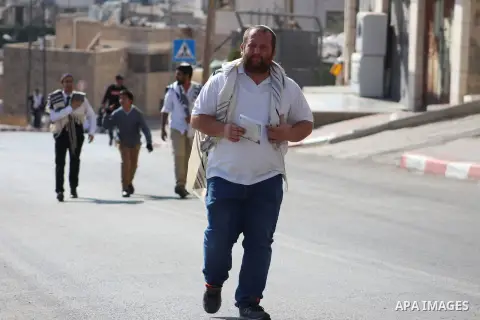 A group of Israeli Ultra Orthodox Jews on their way to visit the tomb of Othniel Ben Kenaz in an Arab neighbourhood of the divided, West Bank city of Hebron on November 23, 2019. Photo by Mosab Shawer
