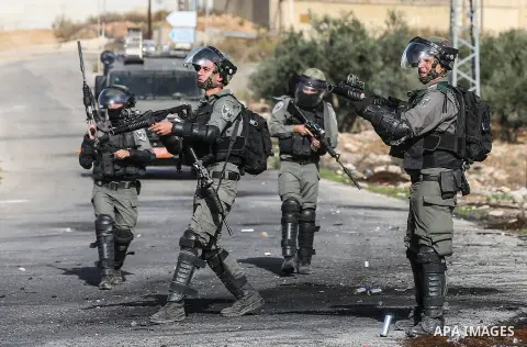 Palestinian protesters reacts to tear gas during a protest as Palestinians call for a day of rage over U.S. decision on settlements, near the settlement of Beit El in the West Bank November 26, 2019. Photo by Mashhor Wah...