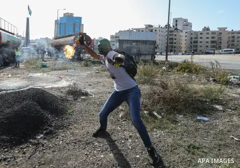 Palestinian protesters reacts to tear gas during a protest as Palestinians call for a day of rage over U.S. decision on settlements, near the settlement of Beit El in the West Bank November 26, 2019. Photo by Mashhor Wah...