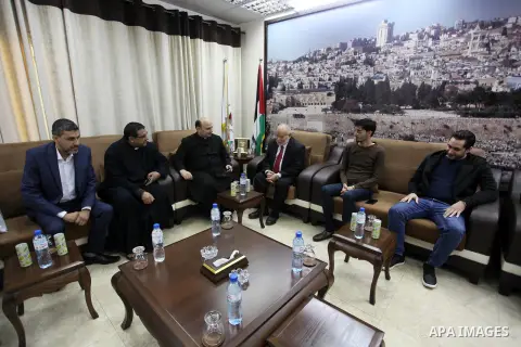 Deputy of the Legislative Council, Ahmed Bahar, meets Father Youssef, the priest of the parish of the Christian community in Gaza city, on December 01, 2019. Photo by Mahmoud Ajjour
