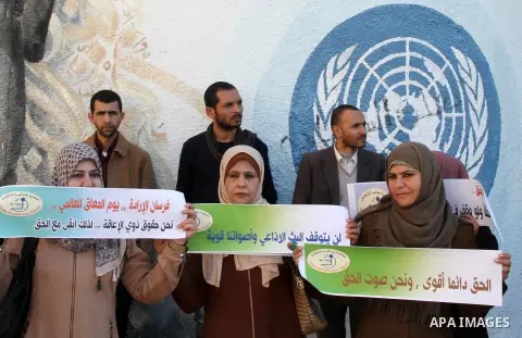 Palestinians participate in a protest against UNRWA's decision to terminate the contracts of journalists Radio "Forsan alerada" in front of its headquarters, in Gaza city, on December 5, 2019. Photo by Mohammed Mostafa