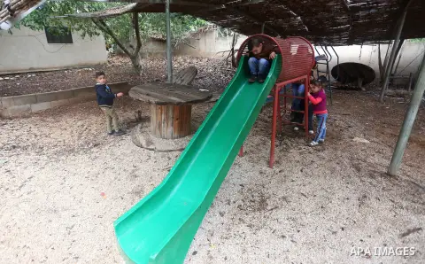 Palestinian schoolchildren attend a lesson after Israeli troops confiscated caravans used as school classrooms, due to the lack of an Israeli-issued construction permit, at Ghassan Kanafani Kindergarten in the West Bank...