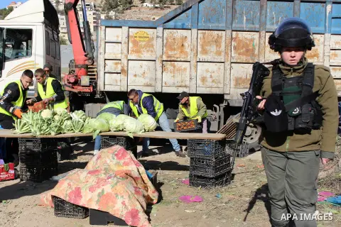 Israeli occupation forces confiscate the Palestinian sellers' vegetables and fruit in the village of Al-hegra east of Dora city, south of Hebron, on 16 December 2019. Photo by Mosab Shawer