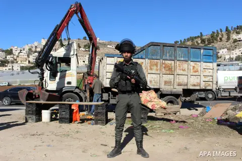 Israeli occupation forces confiscate the Palestinian sellers' vegetables and fruit in the village of Al-hegra east of Dora city, south of Hebron, on 16 December 2019. Photo by Mosab Shawer