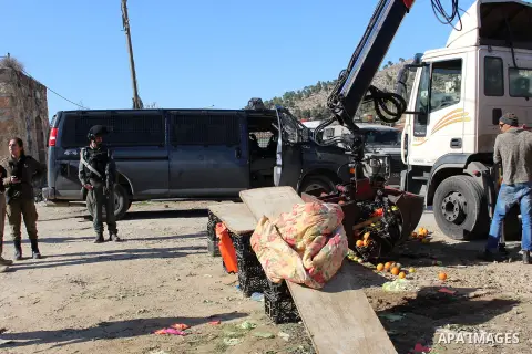 Israeli occupation forces confiscate the Palestinian sellers' vegetables and fruit in the village of Al-hegra east of Dora city, south of Hebron, on 16 December 2019. Photo by Mosab Shawer