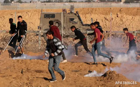 Palestinian protesters clash with Israeli troops following the tents protest where Palestinians demand the right to return to their homeland at the Israel-Gaza border, in Khan Younis in the southern Gaza Strip, on Decemb...