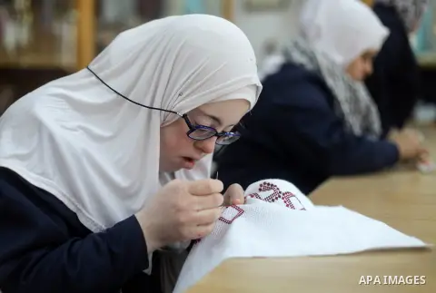 Palestinian women with Down syndrome work on embroidery at association "Right of life" in Gaza city, on December 22, 2019. In the blockaded Gaza Strip with a population of 2 million, there are about 1,800 people with Dow...