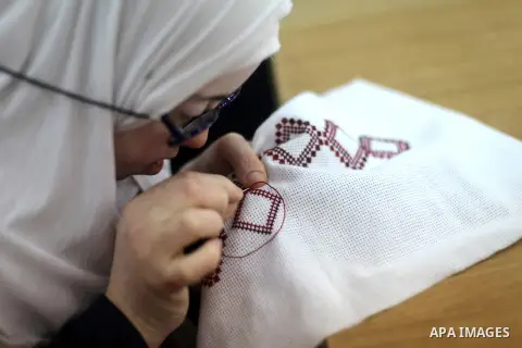 Palestinian women with Down syndrome work on embroidery at association "Right of life" in Gaza city, on December 22, 2019. In the blockaded Gaza Strip with a population of 2 million, there are about 1,800 people with Dow...