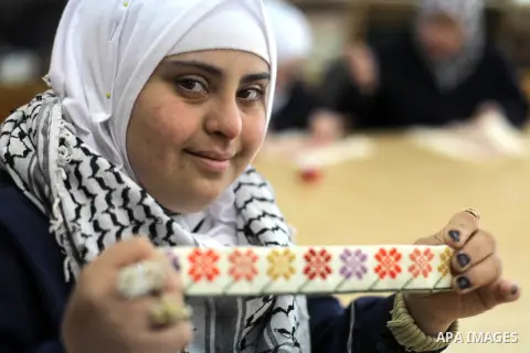 Palestinian women with Down syndrome work on embroidery at association "Right of life" in Gaza city, on December 22, 2019. In the blockaded Gaza Strip with a population of 2 million, there are about 1,800 people with Dow...