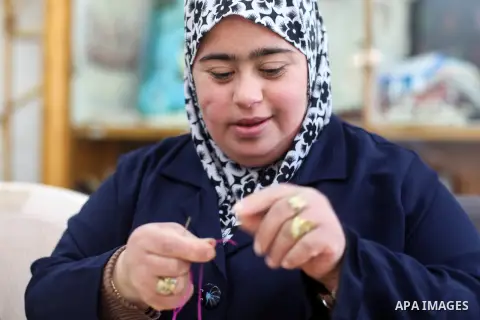 Palestinian women with Down syndrome work on embroidery at association "Right of life" in Gaza city, on December 22, 2019. In the blockaded Gaza Strip with a population of 2 million, there are about 1,800 people with Dow...