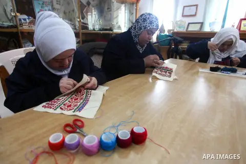 Palestinian women with Down syndrome work on embroidery at association "Right of life" in Gaza city, on December 22, 2019. In the blockaded Gaza Strip with a population of 2 million, there are about 1,800 people with Dow...