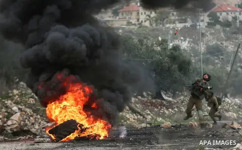 Israeli security forces fires tear gas at the Palestinian youth during clashes with Palestinian protesters following a weekly demonstration against the expropriation of Palestinian land by Israel in the village of Kfar Q...