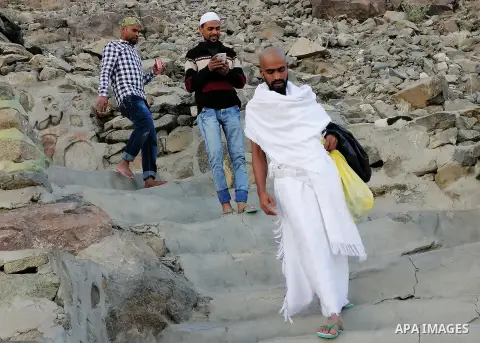 Muslim pilgrims pray at Mount Al-Noor during the Umrah pilgrimage rite in the holy city of Mecca, Saudi Arabia, on January 24, 2020. Mount Al-Noor houses Ghar-E-Hira or Hira cave, where Prophet Mohammad is said to have s...