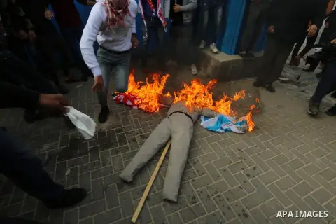 Palestinians supporters of the Democratic Front for the Liberation of Palestine (DFLP) burn an effigy depicting U.S. President Donald Trump during a protest against the U.S. Middle East peace plan, in front of the headqu...