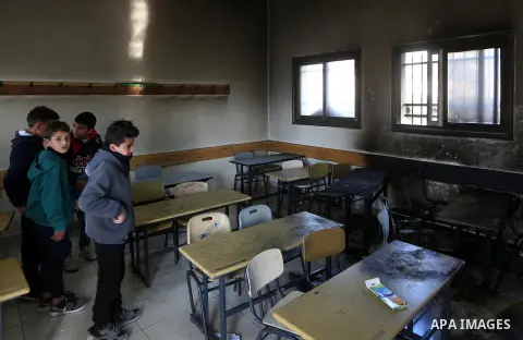Palestinians inspect a burnt school classroom damaged by fire in Einabus village, near the West Bank city of Nablus, on January 28, 2020 after school was vvandalized in an apparent attack by Jewish settlers. Photo by Sha...
