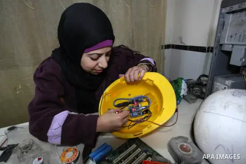 A Palestinian Doaa Geneina, 36, invents an air-conditioned electronic hat, at her home in Gaza city, on February 1, 2020. Geneina, invented the hat for all people, special needs, cancer patients, and engineers for used i...