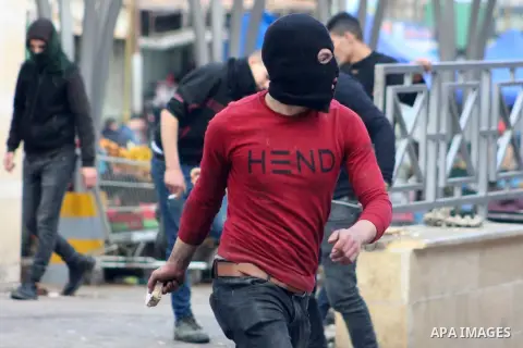 Palestinian protesters hurls a stones towards Israeli security forces during clashes with Palestinian protesters following a demonstration against US President Donald Trump's Century Deal "expected peace plan" in the Wes...