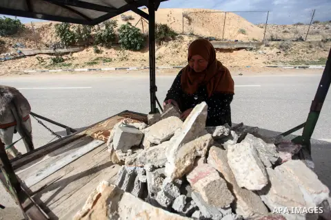 Palestinian woman Jihad Abu Mohsen, 50, collects stones for sale in Khan Yunis in the southern of Gaza Strip on February 18, 2020. Abu Mohsin has been working in the stone profession for 7 years to support her family. Ph...
