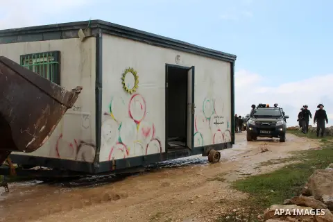An Israeli bulldozer removes caravan used as school classrooms, at the village of Susia outside the West Bank village of Yatta, on February 19, 2020. Israel plans on annexing 36 settlements in the area, housing some 9,00...