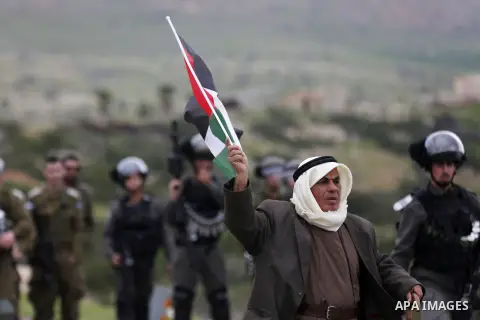 A Palestinian demonstrator stands in front of Israeli forces during a protest against Israeli settlements and the US President Donald Trump's Century Deal "expected peace plan", in the West Bank city of Tubas, on Februar...