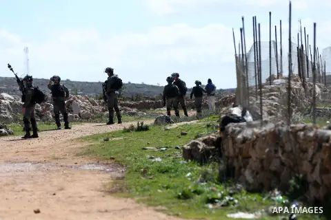 Israeli soldiers arrest a Palestinian protester during the bulldozing operations carried out by the occupation bulldozers in the lands of the towns of Qasra and Jureesh, south of the West Bank city of Nablus on March 1,...