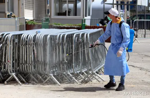 Palestinian workers disinfect gates and barriers near the near the Ibrahimi mosque in the Old city of the West Bank city of Hebron as a preventive measure amid fears of the spread of the novel coronavirus, on March 11, 2...