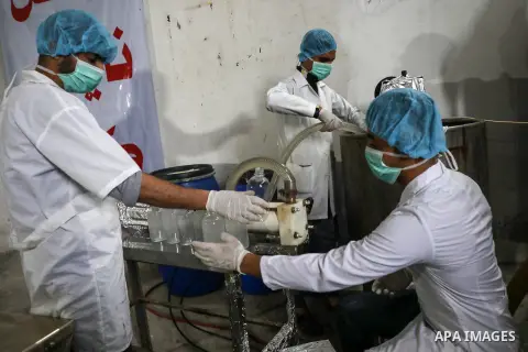 Palestinian factory workers work in the manufacture of disinfectants on a production line at a chemical agent production facility in Gaza City, on March 17, 2020. Production of disinfectants in factories has increased re...