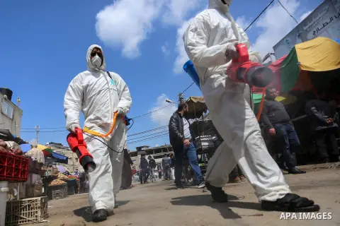 Palestinian workers disinfect a markets, as a preventive measure amid fears of the spread of the novel coronavirus, in gaza city, on March 19, 2020. For most people, the new coronavirus causes only mild or moderate sympt...