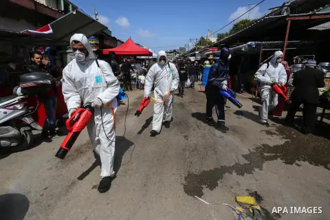 Palestinian workers disinfect a markets, as a preventive measure amid fears of the spread of the novel coronavirus, in gaza city, on March 19, 2020. For most people, the new coronavirus causes only mild or moderate sympt...