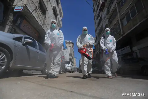 Palestinian workers disinfect the streets, as a preventive measure amid fears of the spread of the coronavirus, in Gaza City on March 22, 2020. Authorities in Gaza confirmed the first two cases of novel coronavirus, iden...