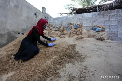 A Palestinian artist Rana el-Ramlawi, 23, creates a sand sculpture " stay home" during awareness campaign about the spread of coronavirus disease (COVID-19), at her house Gaza city, on April 3, 2020. The United Nations h...