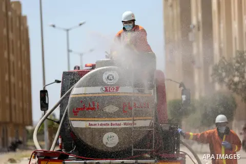 Palestinian workers spray disinfectant as a preventive measure amid fears of the spread of the coronavirus disease (COVID-19), in Hamad Town, in Khan Youns southern in Gaza City n April 12, 2020. Photo by Ashraf Amra