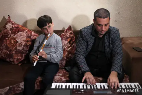 A Palestinian music arranger, Ahmed Al-Ayoubi, gives a music lesson to his sons at their home as a preventive measure amid fears of the spread of the coronavirus disease (COVID-19), in Gaza City April 14, 2020. Photo by...