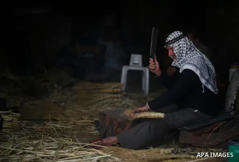 A Palestinian man, Sabri Dweikat, 70, makes traditional straw brooms, since 40 years, in the West Bank city of Nablus, on April 20, 2020. The production and sale of straw brooms were reduced due to the coronavirus diseas...