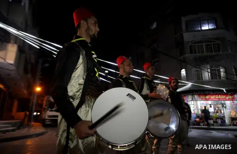 Palestinian dawn awakeners ''al-Musaharati'' walk through streets to wake up Muslims for a meal before sunrise during the fasting month of Ramadan, in Jabalia in the northen of Gaza strip, on April 29, 2020. Al-Musaharat...