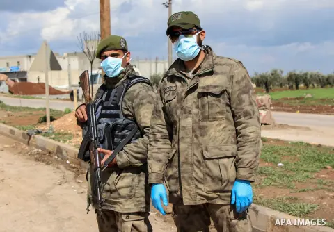 A photo taken on March 30, 2020, shows Syrian policemen wearing masks as a preventive measure amid fears of the spread of the coronavirus disease (COVID-19) in the northern Syrian city of Azaz. Photo by Nayef ALaboud