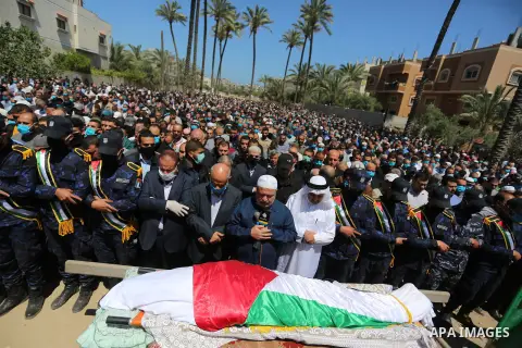 Palestinians wearing protective face masks, attend a funeral of Hamas leader, Ahmad Al-Kurd, in Deir Al-Balah in the central Gaza Strip, on May 10, 2020. Photo by Ashraf Amra
