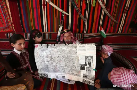 Palestinian refugee, Mahmoud Abu Deeb, 82, sits with his grandchildren, as he talks his story, marking 72th anniversary of Nakba also known as Day of the Catastrophe in 1948, in Khan Younis in the southern of Gaza strip,...