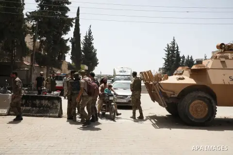 Syrian members of the Police and general security, search cars as they secure the area, at the entrance to the market in Azaz city, north of Aleppo, Syria, May 18, 2020. Photo by Nayef ALaboud