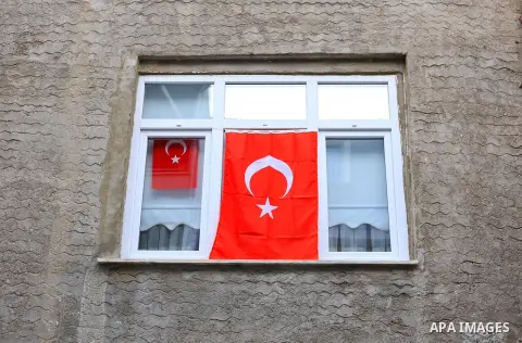 People display national flags to mark the Youth and Sports Day in Istanbul on May 19, 2020 during a four-day curfew aimed at curbing the spread of the COVID-19 pandemic, caused by the novel coronavirus. Photo by Mahmoud...