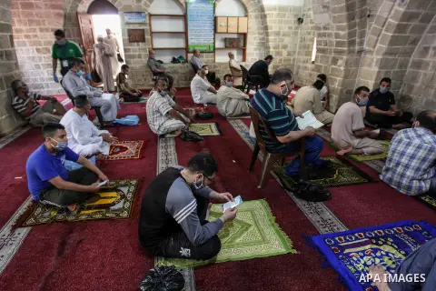 Palestinians wearing masks attend Friday prayers in a mosque as the holy places reopen to worshippers to perform the weekly Islamic ritual, amid concern about the spread of the coronavirus disease (COVID-19), in Gaza Cit...