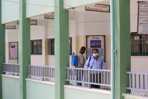 Palestinian workers disinfect a school, for the final high school exams, known as "Tawjihi", as a preventive measure amid fears of the spread of the novel coronavirus, in Nuseirat in the center of Gaza Strip on May 28, 2...
