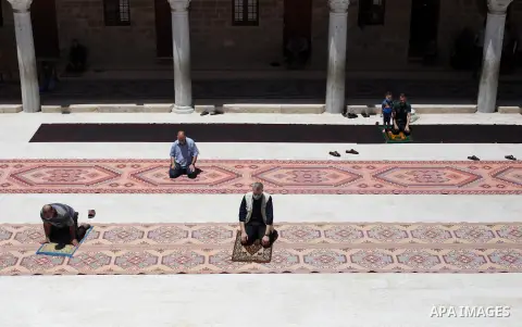 Palestinians wearing masks attend Friday prayers in a mosque as the holy places reopen to worshippers to perform the weekly Islamic ritual, amid concern about the spread of the coronavirus disease (COVID-19), in Gaza Cit...