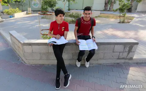 Palestinian students wait for the start of final high school exams at a school in Khan Younis in the southern of Gaza strip on May 30, 2020, amid concerns about the spread of the novel coronavirus pandemic. More than 784...