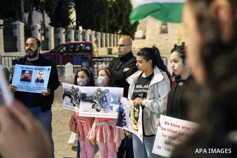 Palestinian protesters hold banners to show solidarity with the martyr Iyad Hallaq a disabled Palestinian man who was shot dead by Israeli police after they mistakenly thought he was armed with a pistol, and also to show...